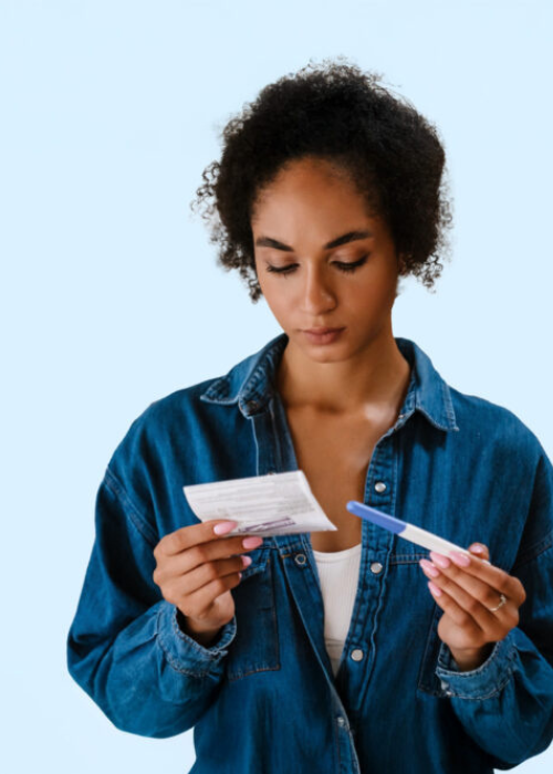 A woman looking at a pregnancy test